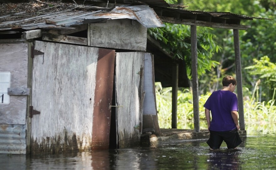 Zeth Rogers walks through the flooding Atchafalaya River in Simmesport, La. The Army Corps of Engineers opened another bay on the Morganza Spillway Wednesday — diverting more water off the Mississippi through the bayous and rivers of the Atchafalaya Basin.