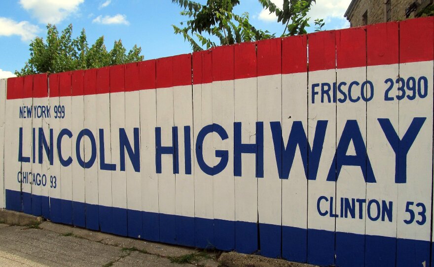 A large sign outside the Lincoln Highway Association headquarters in Franklin Grove, Ill., gives travelers a rough mileage to various spots along the route, including New York and San Francisco.