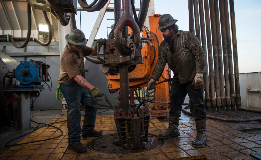 Workers with line up pipe while drilling for oil in the Bakken shale formation outside Watford City, N.D., an area experiencing an oil boom.