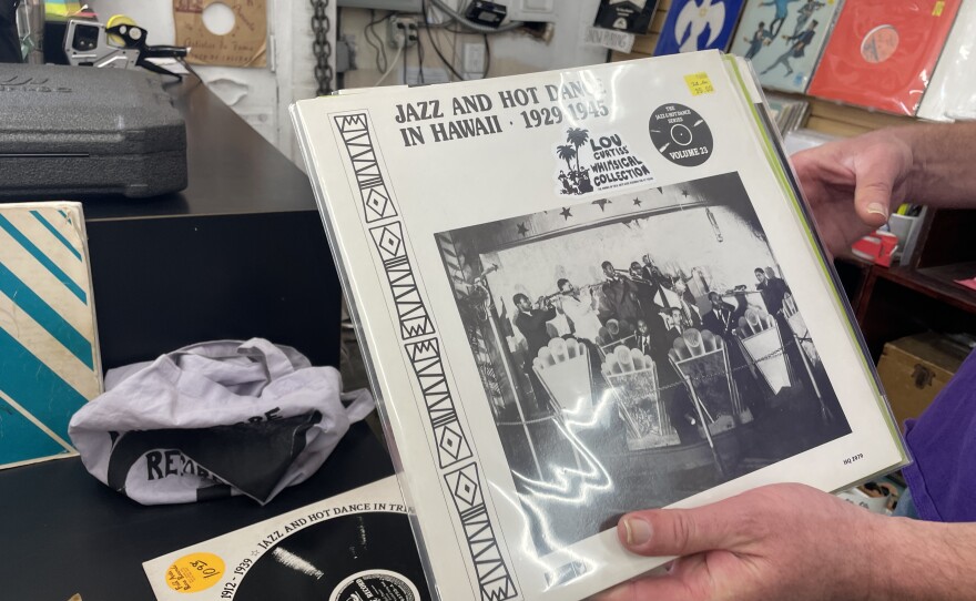 Brendan Boyle of Folk Arts Rare Records holds one of the albums from the Lou Curtiss Whimsical Collection, "Jazz and Hot Dance in Hawaii - 1921-1945," shown on Dec. 12, 2025.