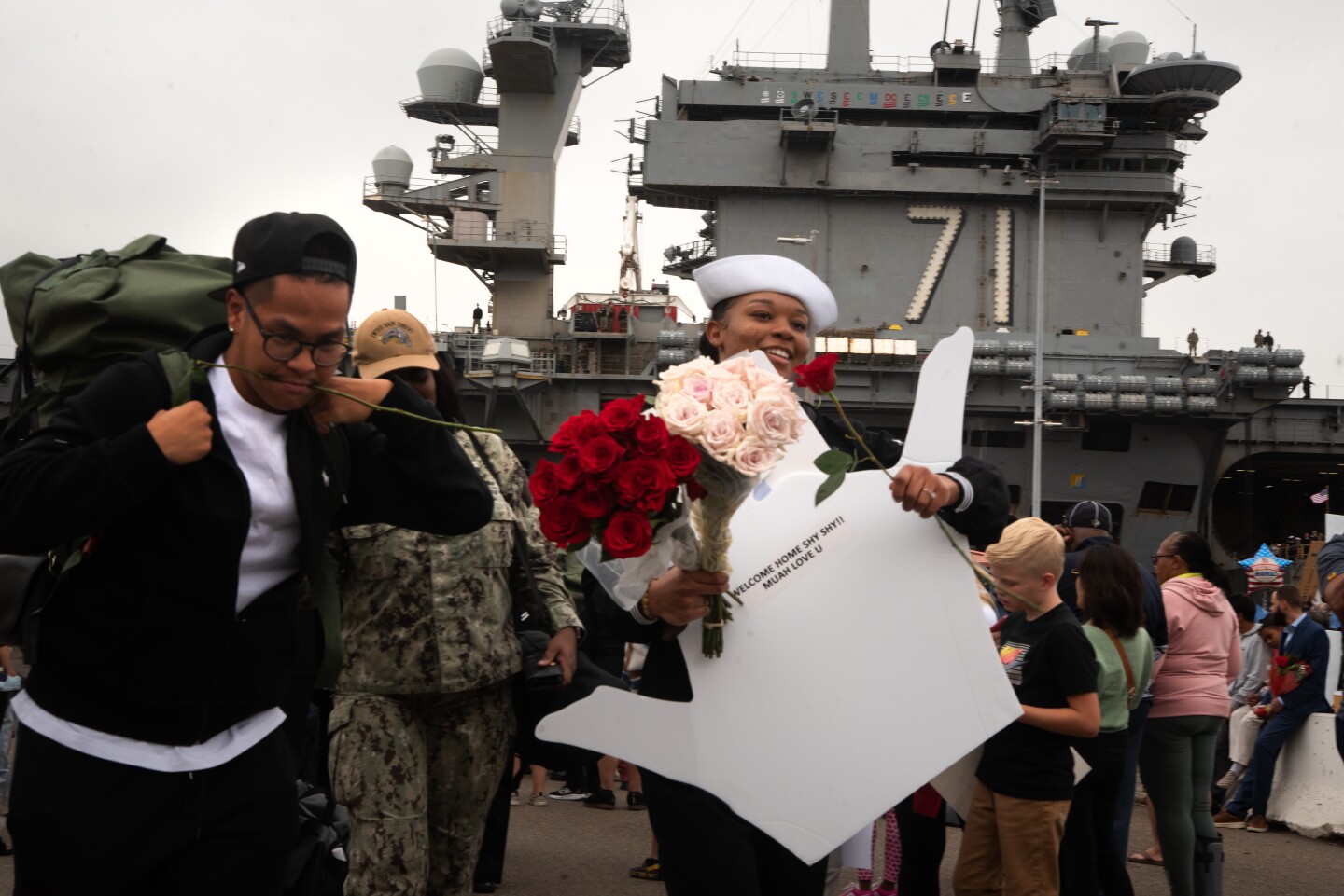 A sailor walking through the crowd after leaving the aircraft carrier Theodore Roosevelt on Oct. 15, 2024 at the Naval Air Station North Island on Coronado Island.