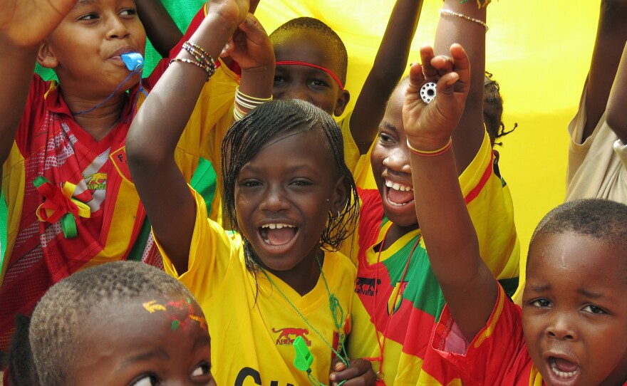 Children showed off Guinea's national colors before their team's opening match with Ivory Coast in the Africa Cup of Nations.