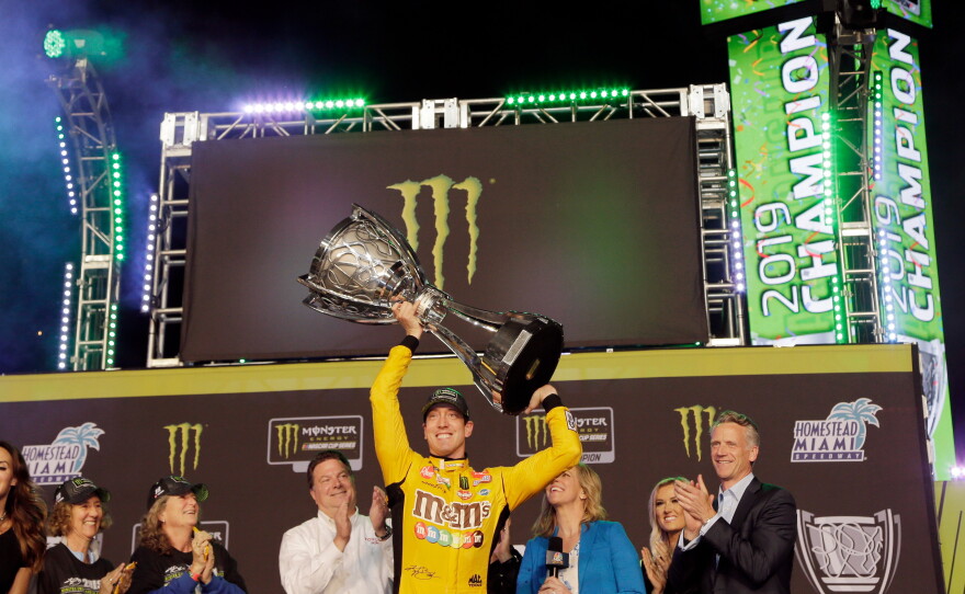 In this Nov. 17, 2019, file photo, Kyle Busch holds up the trophy in Victory Lane after winning a NASCAR Cup Series auto racing season championship at Homestead-Miami Speedway in Homestead, Fla.