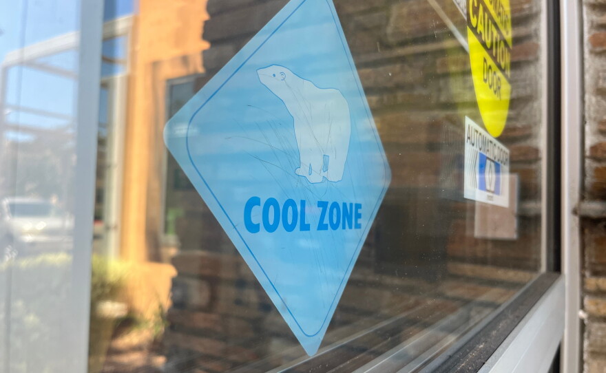 A sign that says "Cool Zone" hangs in the window of the San Marcos Library on July 31, 2026.