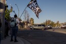 A protester waves a Black Lives Matter flag on the corner of Ashwood and Mapleview in Lakeside Saturday, early evening, during a rally and protest against hate in response to the stabbing of a teenage black girl by a 16-year-old boy, an apparent hate crime, April 23, 2022.