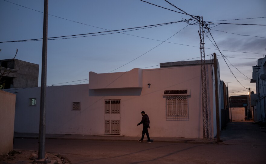 A man walks down a street in Jelma. Jelma is one example of the many interior towns of Tunisia suffering from high unemployment rates and overall lack of development.
