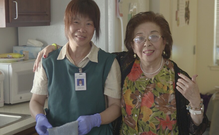 Belle with a housekeeper provided by On Lok, a San Francisco program that makes it possible for aging seniors with chronic illnesses or disabilities to remain in their own homes.