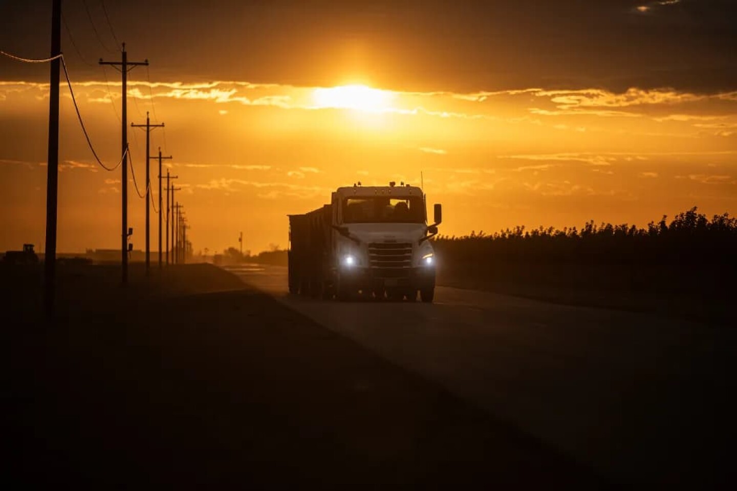 A truck carrying crops drives through farmland outside of Firebaugh in Fresno County on Sept. 24, 2025. Photo by