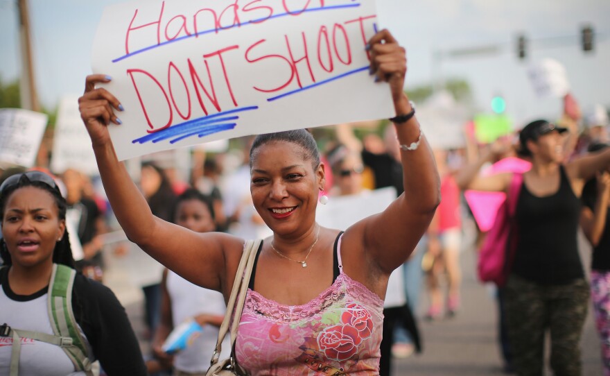 Protests against the police shooting and killing of teenager Michael Brown had a different feel Thursday in Ferguson, Missouri. Police scaled back their military-style operations and instead walked with protesters.