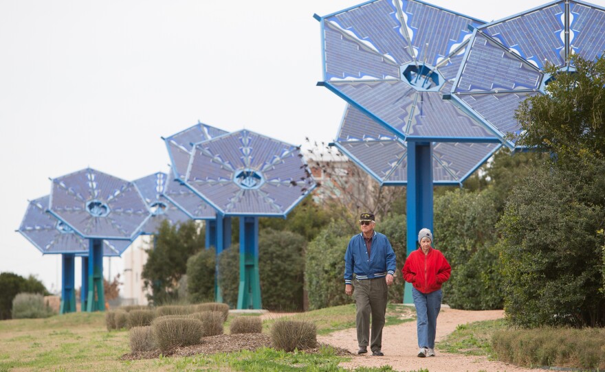 Solar Sunflowers, an art installation, greets visitors to Mueller's commercial and retail hub off of Interstate 35. The panels power a nightly light display and return power to the grid. When the development is complete, five miles of granite trails will connect the residents to its commercial and retail hubs.