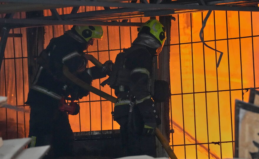 Firefighters work on the site of a burning building after a Russian missile attack in Kyiv, Ukraine, Tuesday, June 2, 2026.