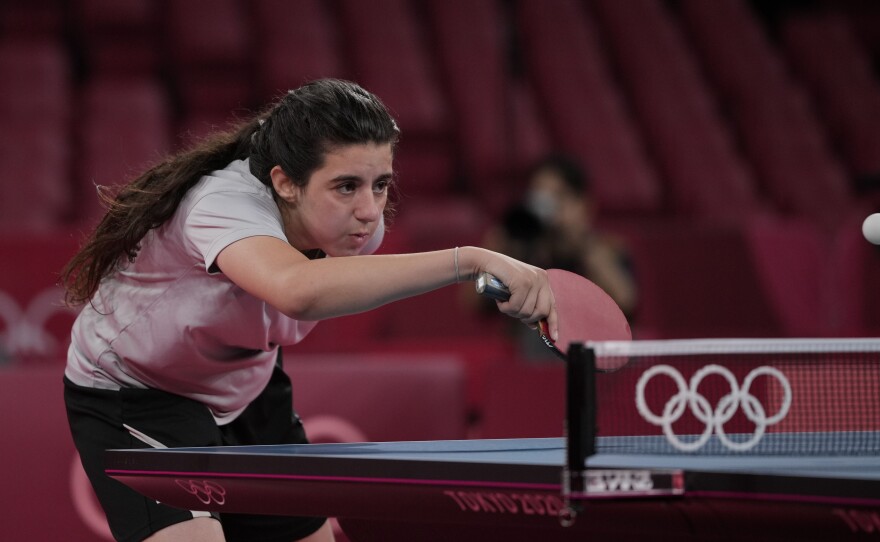 Syria's Hend Zaza competes during women's table tennis singles preliminary round match against Austria's Liu Jia at the 2020 Summer Olympics in Tokyo.