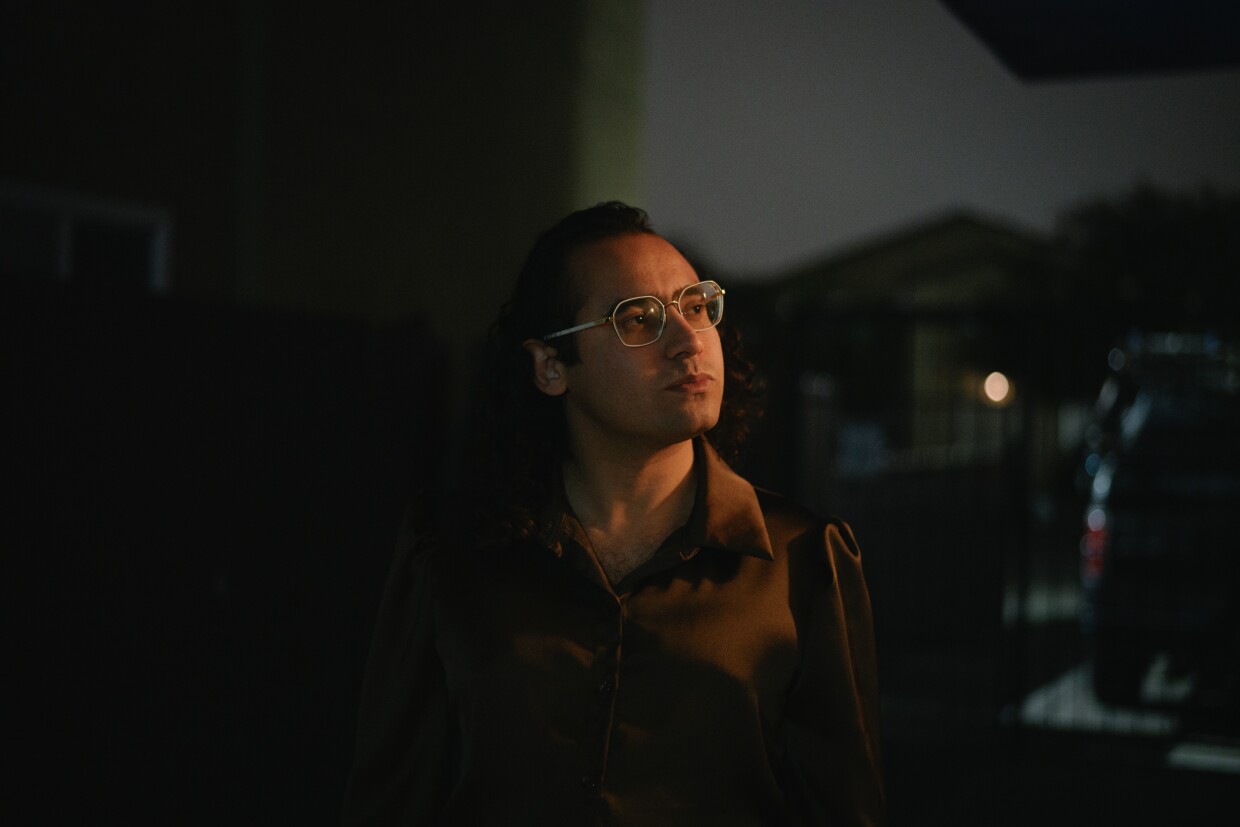 Raul Ureña, former mayor of Calexico and an advocate for Imperial County’s transgender community, stands for a portrait outside their home in San Diego, California on February 5, 2025. Ureña has been an outspoken critic of the Imperial Valley LGBT Center’s effort to rebrand itself as the Donnelly Center.