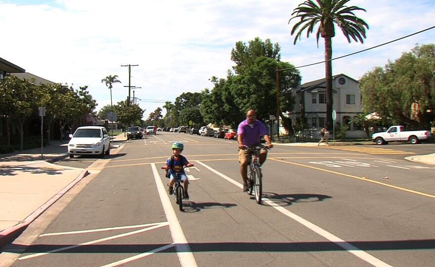 A father and son ride down a bike lane next to Coronado's elementary school, Sept. 22, 2015.