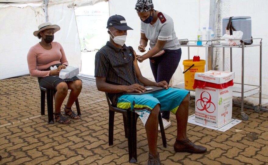 A man receives a dose of a COVID-19 vaccine in Soweto, South Africa. The omicron variant of the coronavirus, first identified in South Africa, has now spread to at least a dozen other countries. On Friday, scientists presented evidence that the variant spreads twice as fast as the delta variant.