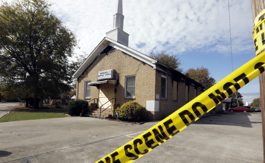 Crime scene tape outlines the perimeter of the Hopewell Missionary Baptist Church in Greenville, Miss., on Nov. 22. A member of the church has been arrested and charged with arson for the Nov. 1 burning of the building, the Associated Press reports.
