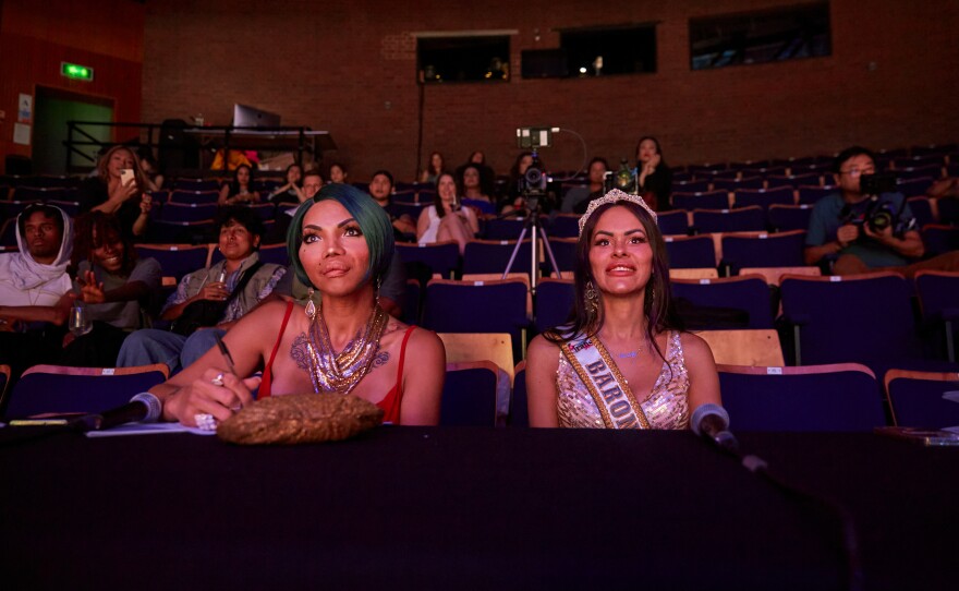 Head judge Madame Brazil (left) and judge Danielly Drugge (right) watch as the Miss Trans Global contestants present their grand final gowns. Worried that the pageant would be targeted by anti-transgender protests, Miss saHHara, the pageant's organizer, chose not to advertise the event. As a result, the pageant's two public nights were sparsely attended.