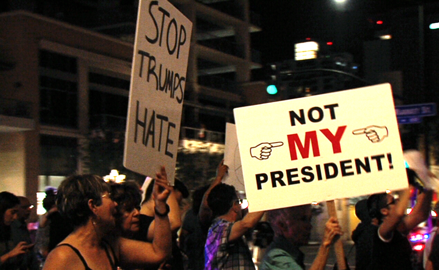 Protesters hold signs reading "Stop Trumps Hate" and "Not My President" in downtown San Diego, Nov. 9, 2016.