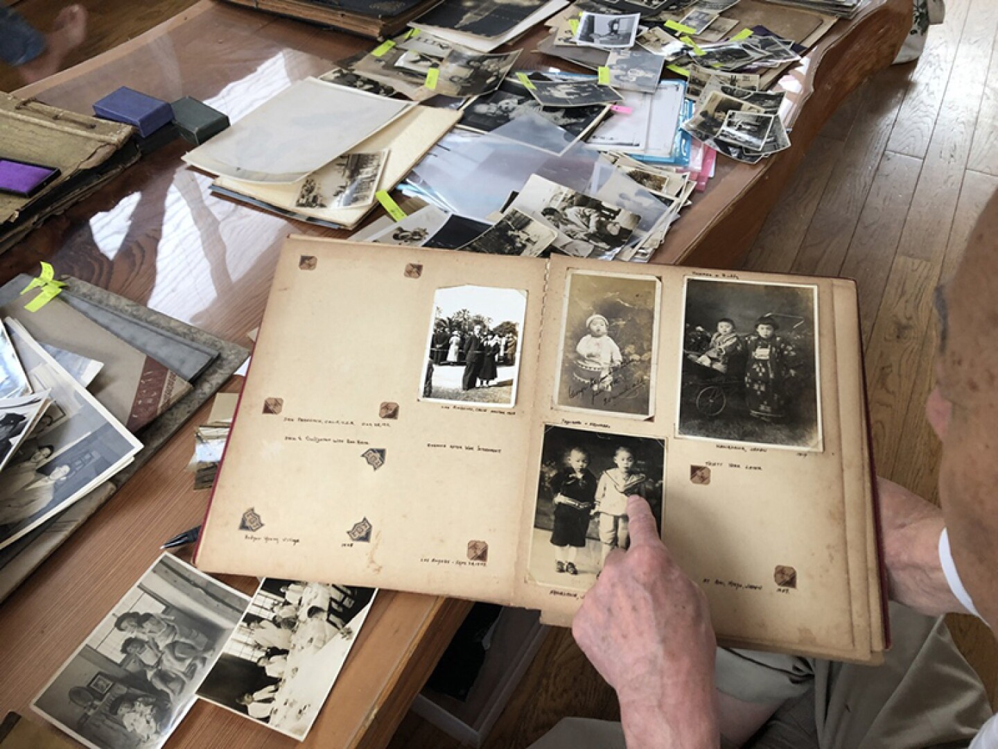 George Uno at home in Japan, looking through archives (Buddy Uno story). Buddy Uno was an American journalist who worked for the Japanese government during WWII.
