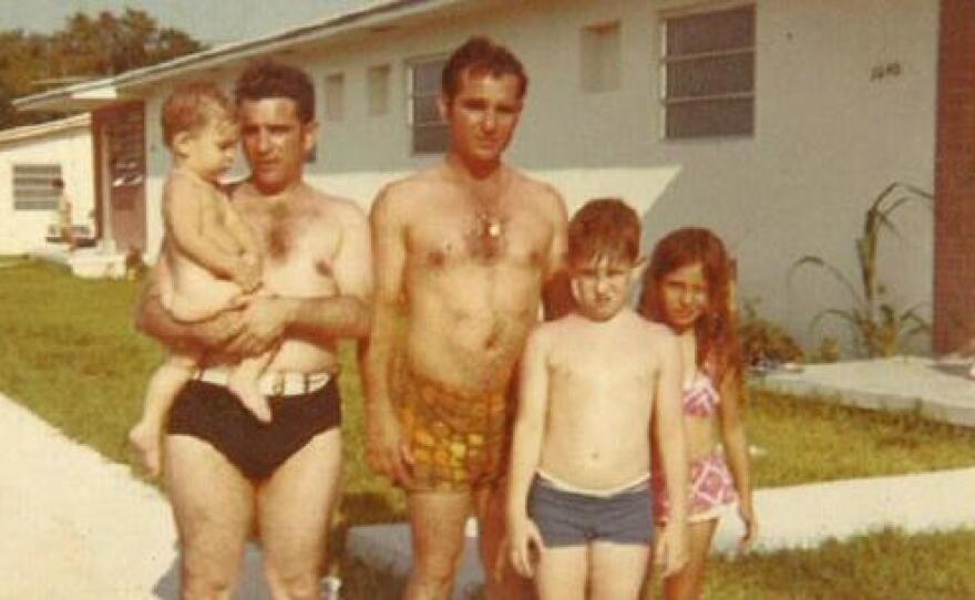 Richard a.k.a 'Little Riqui' after a day at the beach, in the arms of his father Carlos and with his uncle Toti, brother Caco, and cousin Mirita.