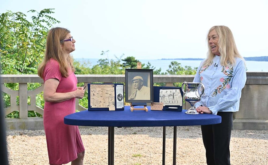 Leila Dunbar (left) appraises a 1909 Neal Ball first unassisted triple play group, in Sands Point, N.Y.