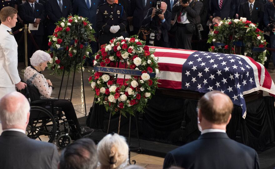 Roberta McCain, mother of John McCain, pays respects before his flag-draped casket Friday at the Capitol rotunda. His final public memorial was Saturday at the National Cathedral.