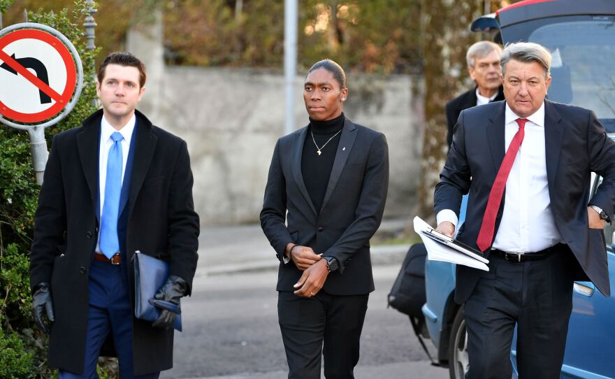 South African Olympic champion Caster Semenya (center) and her lawyer, Gregory Nott (right), arrive for a hearing at the Court of Arbitration for Sport in Switzerland in February.