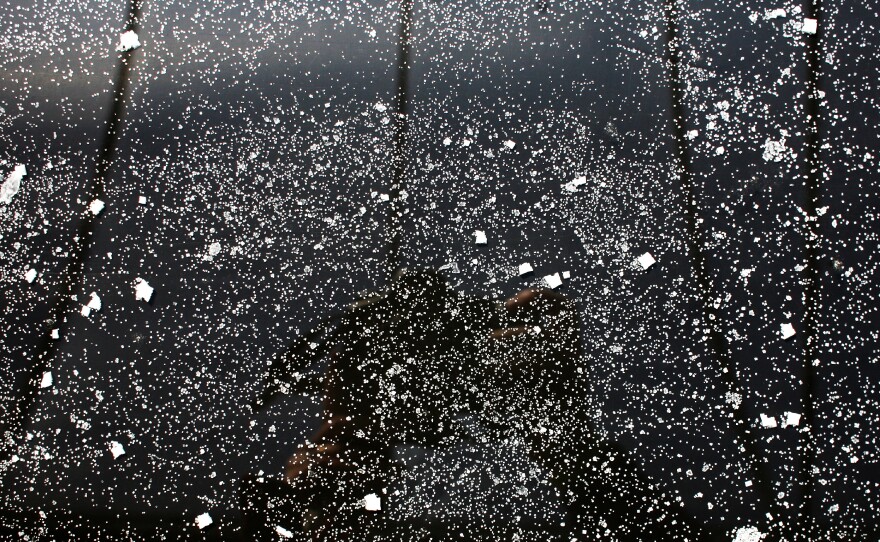Finished salt crystals are spread out on an evaporation table before being raked and packaged.