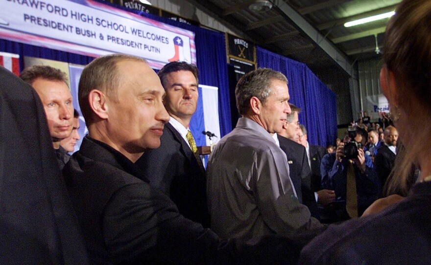 Bush and Putin shake hands with students after speaking at Crawford High School.