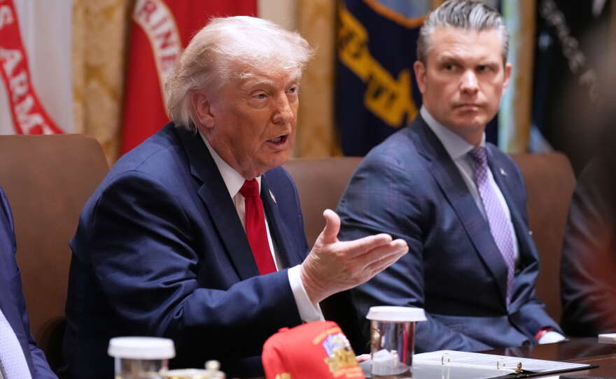 President Donald Trump speaks during a Cabinet meeting at the White House, Wednesday, May 27, 2026, in Washington, as Secretary of Defense Pete Hegseth, looks on.