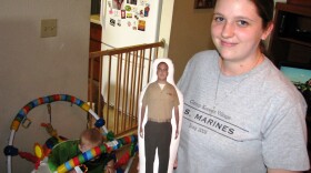 Laura Loasching holds a “daddy doll” of her husband Kurt, who isn’t due back from deployment until next January. 
