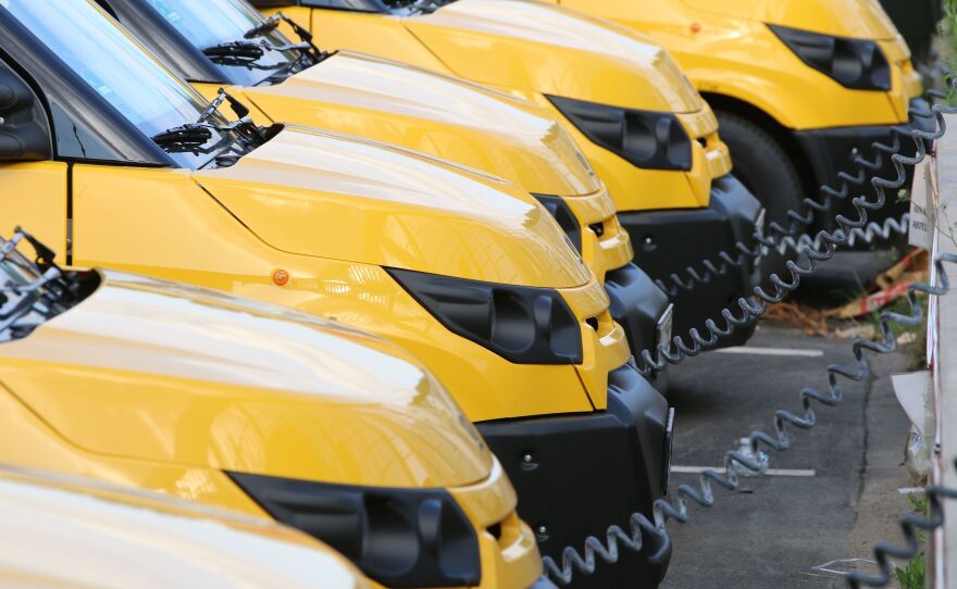 Electric vans charge at a warehouse of the German postal and logistics service Deutsche Post near Frankfurt in July 2018. Fleet vehicles are increasingly going electric in Europe and China, and some analysts say American fleets will be following suit.