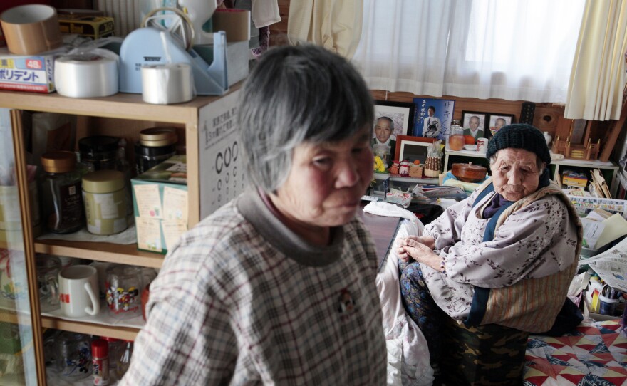 Saki Sato (left), 77, and Chikuyo Yokoyama, 90, are neighbors in the housing project, and visit during the day. Sato lives alone, and Yokoyama lives with her son.