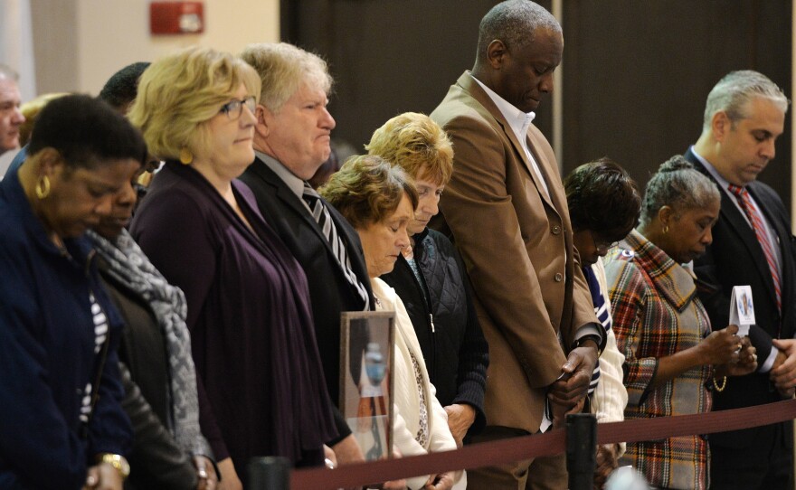 Family members of the crew stand during a moment of silence for those lost on the El Faro ship in February.