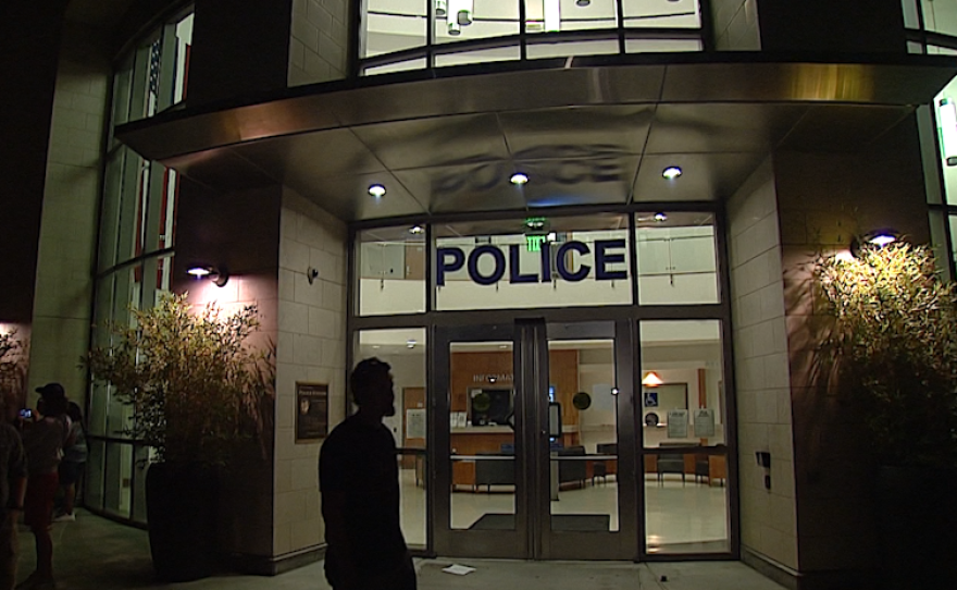 People stand outside a police station in El Cajon, Sept. 26, 2016.