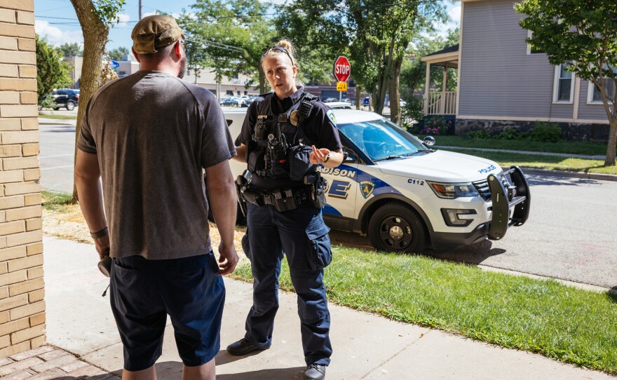 Officer Nicole Schmitgen speaks with a man about a reported disturbance in his home during her patrol on July 18, 2022.