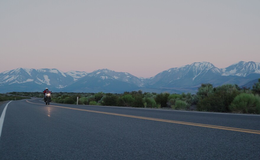 Biker rides through California as the sun rises.