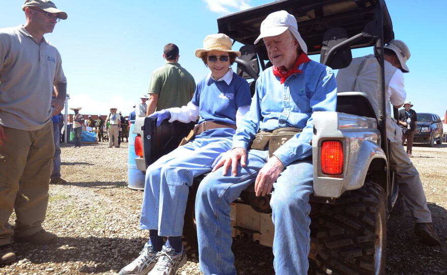 Former first lady Rosalynn Carter and her husband, Jimmy, take a break during a housing work project in Haiti in 2011 for victims of the massive Jan. 12, 2010, earthquake.