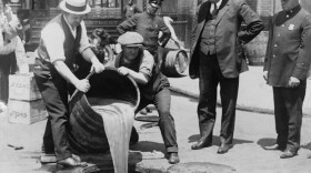 New York City Deputy Police Commissioner John A. Leach, right, watching agents pour liquor into sewer following a raid, ca. 1921. After the Mullan-Gage Act was repealed in 1923, New York police were no longer bound to enforce Prohibition.