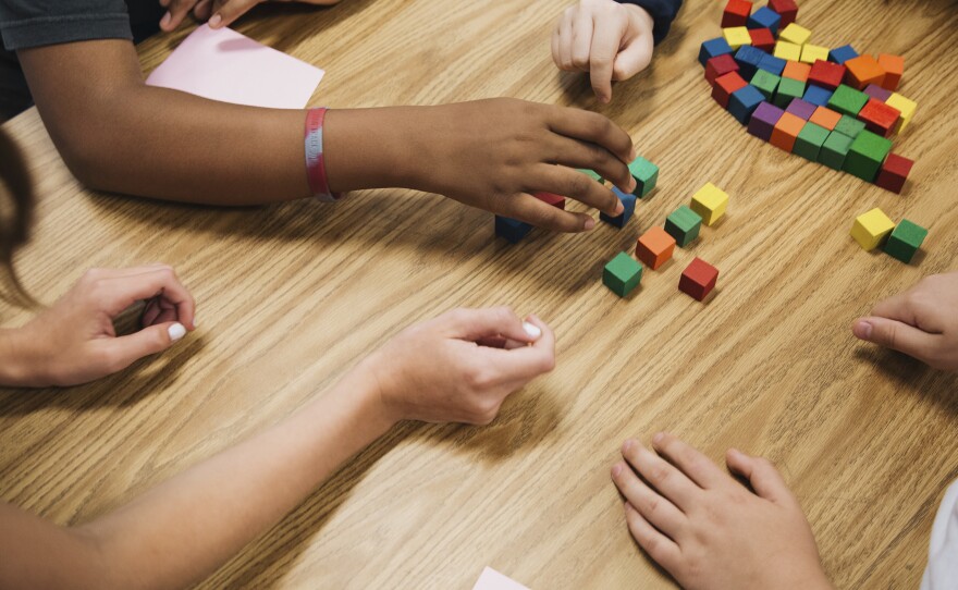 Students work on a group project in math class.