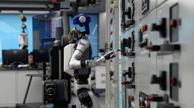 Artificial Intelligence robots demonstrate working on power grid control units during a media organized tour at Guangdong Power Grid Robotics Laboratory in Guangzhou, in southern China's Guangdong province, Thursday, April 16, 2026.