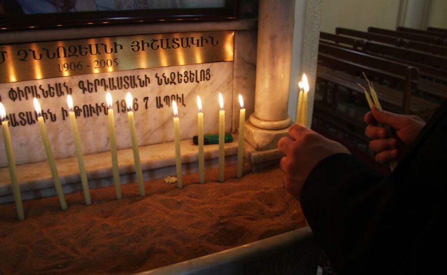 Ahead of Easter Mass, a worshiper lights candles at St. Elie Armenian Catholic Church in downtown Beirut.