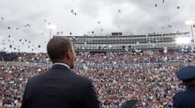 President Barack Obama watches as graduates toss their hats during the United States Air Force Academy commencement ceremony at Falcon Stadium, USAF Academy in Colorado Springs, Colo., May 23, 2012.
