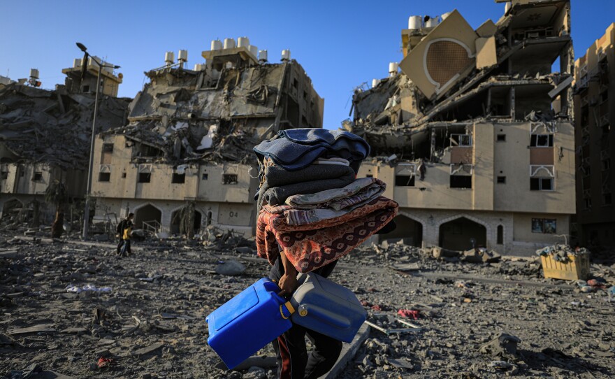 Residents leave the Hamad Towers area, taking some of their belongings with them after the Israeli attacks on Khan Younis, Gaza Strip, Dec. 2, 2023.