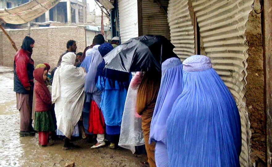 Afghan women wait in line to get bread at a World Food Program-run bakery in Kabul, Afghanistan, in December 2000. The World Food Program provided subsidized bread to about a fifth of the city's population during the Taliban era, from 1996 to 2001.