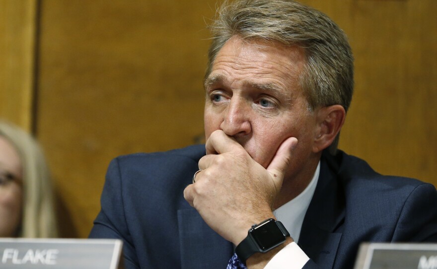 Sen. Jeff Flake, R-Ariz., listens as Christine Blasey Ford testifies before the Senate Judiciary Committee on Thursday.