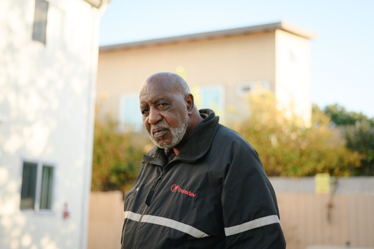 Sherman Qualls stands for a portrait outside his home at The Swell apartments, formerly Sussex Gardens, in Imperial Beach, California on Nov. 18, 2024. Qualls, a retired bus driver, has lived in the building for 18 years.