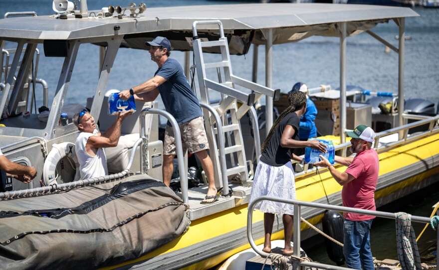 Volunteers load donated items onto Maui Reef Adventures' boat to be distributed to people in Lahaina.