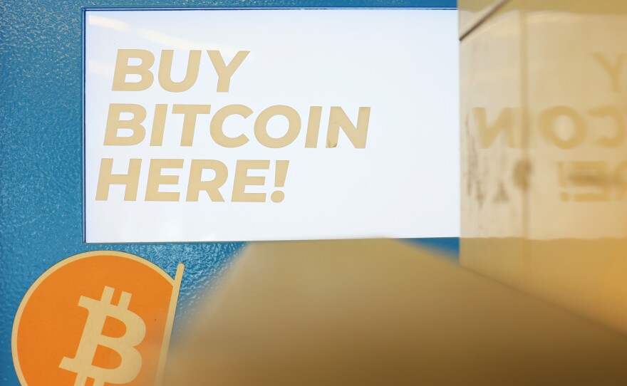 A Bitcoin ATM is seen at a subway station in Brooklyn Heights, New York City, on Monday. Cryptocurrencies such as Bitcoin are slumping as part of a big falls across all kinds of markets.