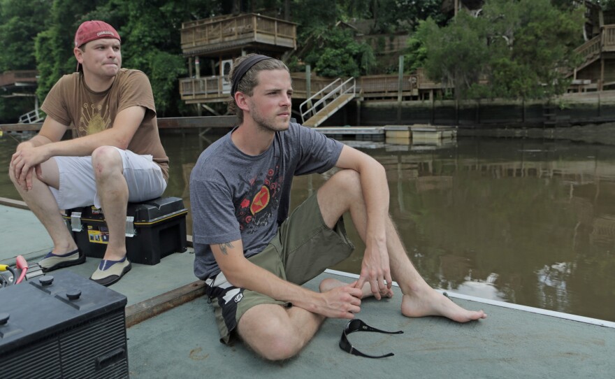 Louis Marcell (left) and Adam Jones prepare to search for old logs, known as sinker wood, on the bottom of Ashley River near Charleston, S.C. They use sonar and a book of old train lines to find the timber, some of which has been preserved in the mud since the 1800s.